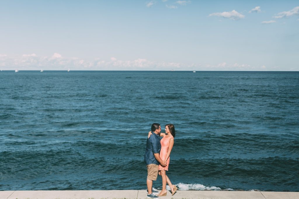 Chicago, Illinois Engagement session on Lake Michigan with a background of the city skyscrapers photography by Sara Anne Johnson