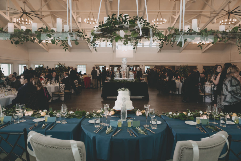 Navy and lemon spring wedding with hanging head table florals at Rockford Bank and Trust Pavilion by Sara Anne Johnson