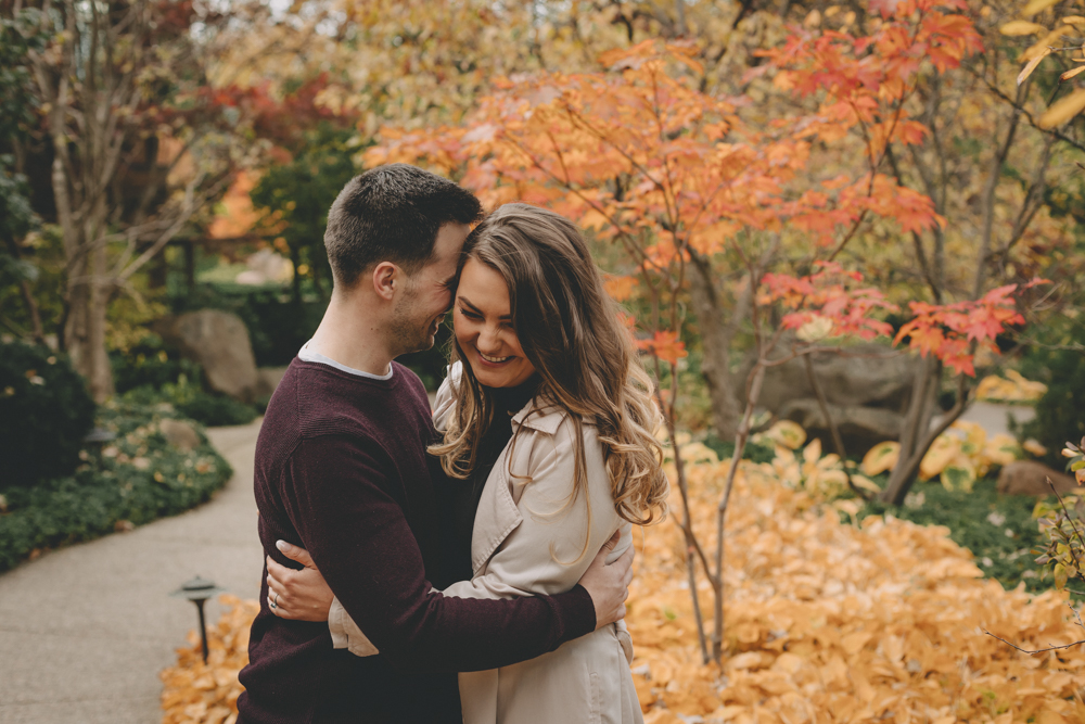 Fall, sunset engagement session with emerald green velvet dress and blue sapphire engagement ring at Anderson Japanese Gardens in Rockford, IL by Sara Anne Johnson - Photographer